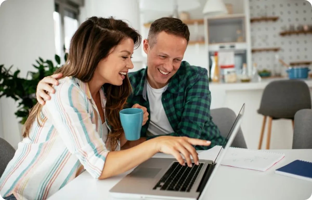 Two Happy People Looking at Laptop