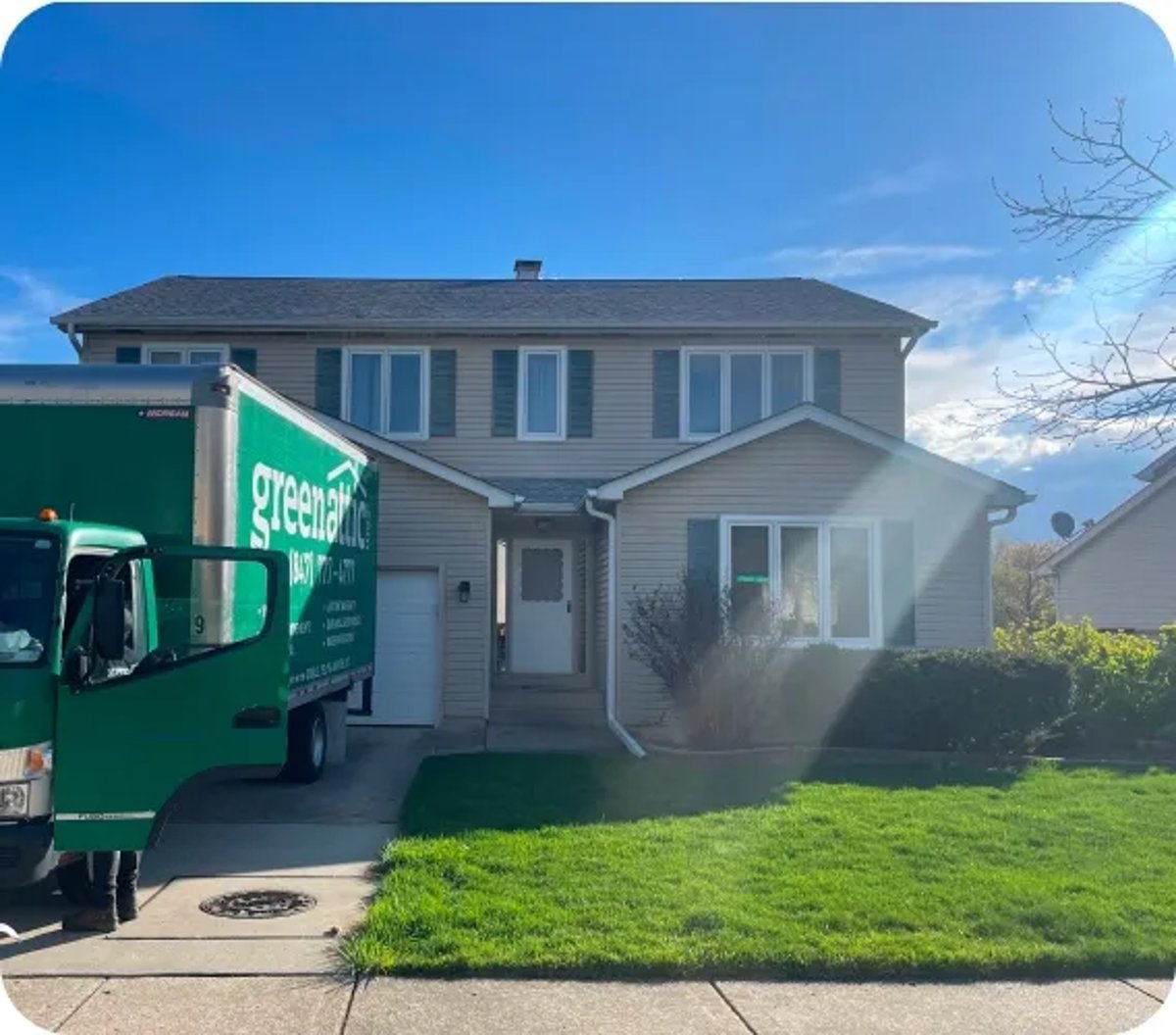 Green Attic Insulation Truck in Front of the House in Summer